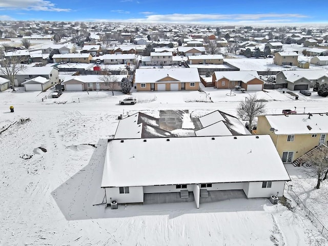 snowy aerial view with a residential view