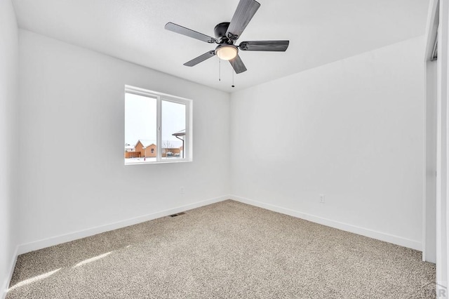 unfurnished room featuring a ceiling fan, carpet, visible vents, and baseboards