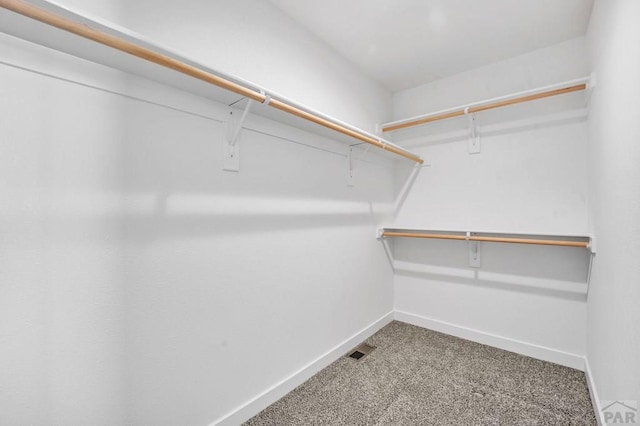 walk in closet with visible vents and carpet flooring