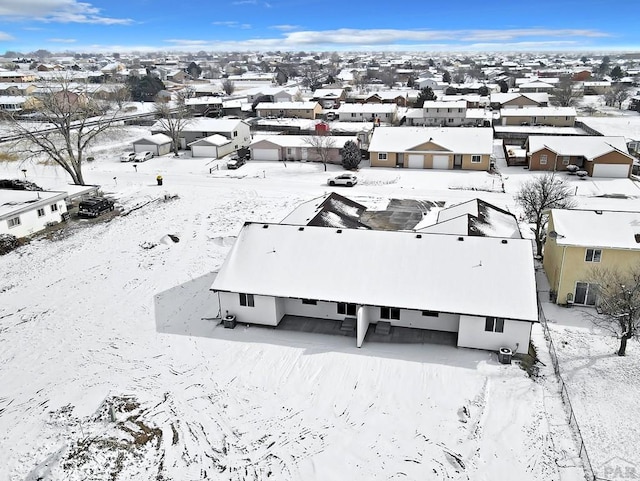 snowy aerial view with a residential view