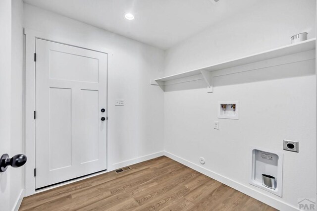 laundry area with hookup for a washing machine, laundry area, visible vents, light wood-style floors, and electric dryer hookup