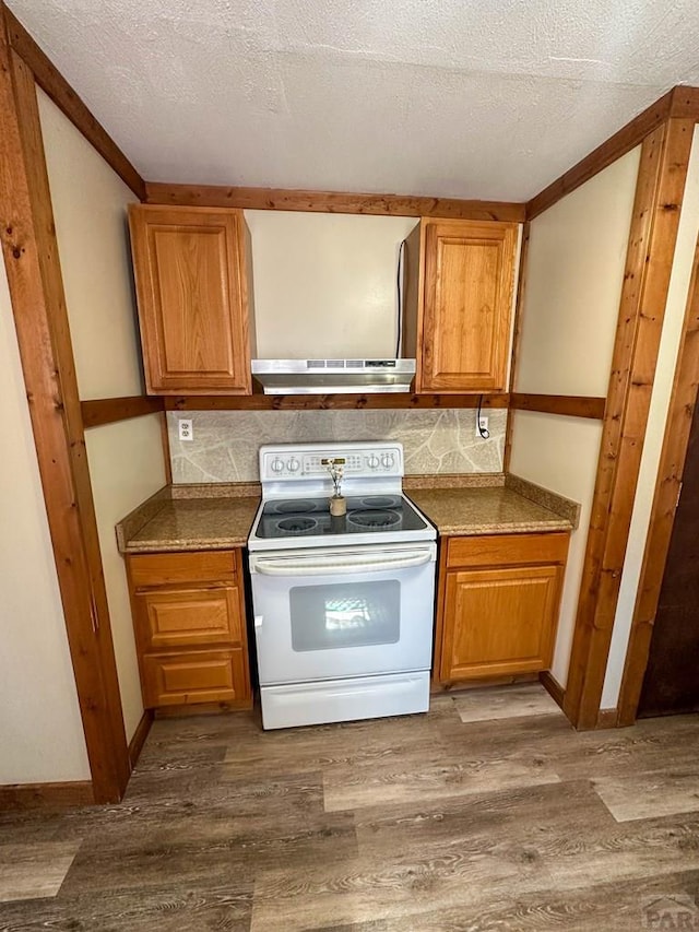 kitchen featuring white electric stove, decorative backsplash, brown cabinets, and wood finished floors