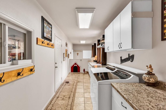 kitchen with light countertops, white cabinets, light tile patterned flooring, and separate washer and dryer