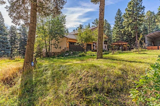 view of yard with a gazebo and an attached garage