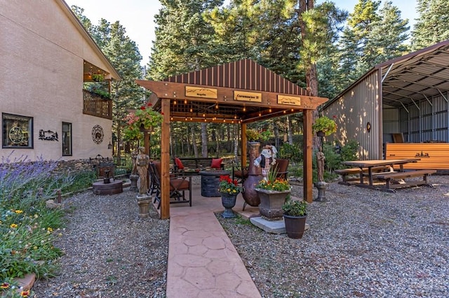 view of patio with a detached carport and a gazebo