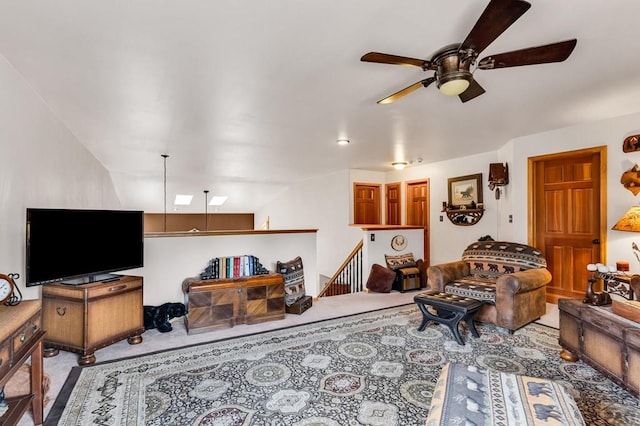 living room featuring carpet and a ceiling fan