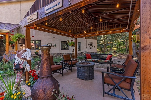 view of patio featuring a gazebo and a fire pit