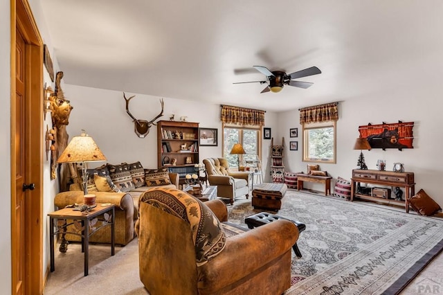 living room featuring a ceiling fan and light colored carpet