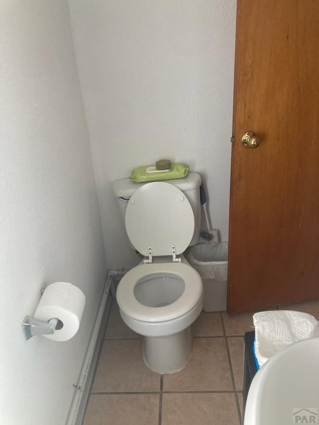 bathroom featuring toilet and tile patterned floors