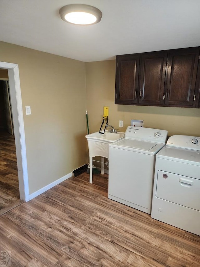 615 San Juan St, Trinidad, CO 81082 - laundry room featuring cabinet space, washing machine and dryer, and light wood finished floors