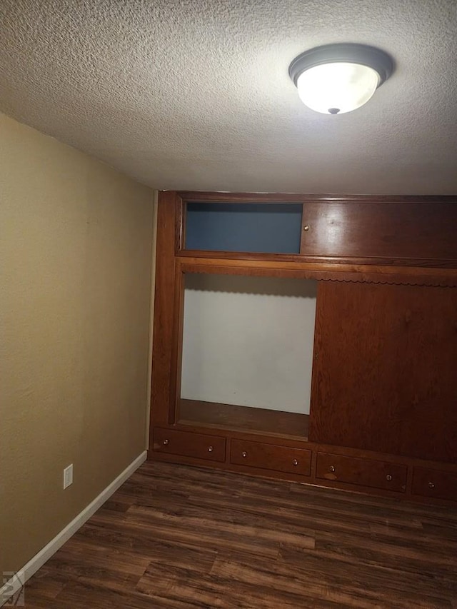 615 San Juan St, Trinidad, CO 81082 - unfurnished room featuring dark wood-style floors and a textured ceiling