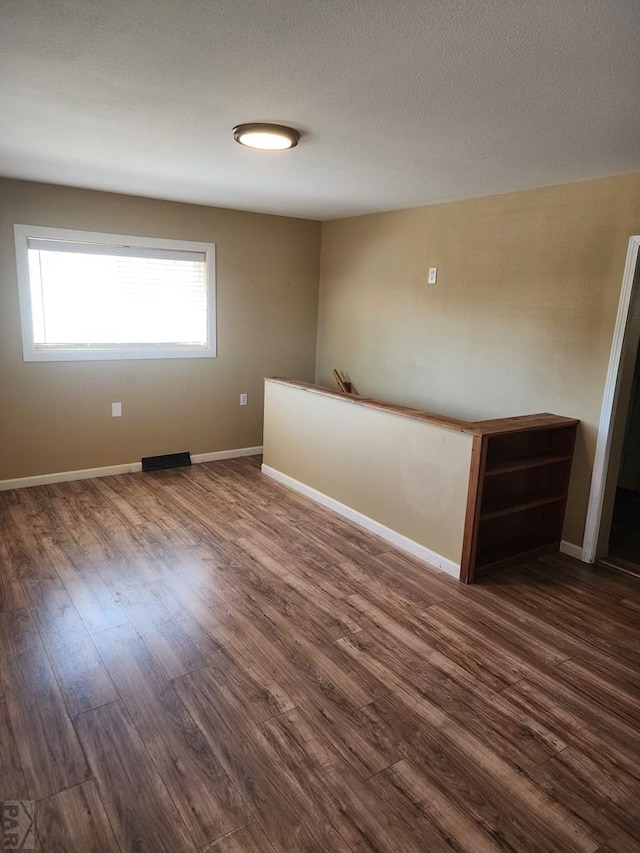 615 San Juan St, Trinidad, CO 81082 - unfurnished room with dark wood-type flooring and baseboards