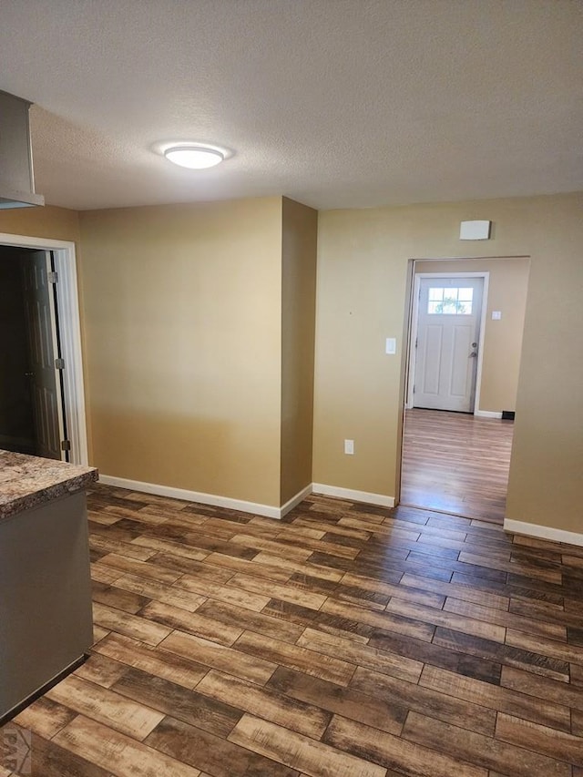 615 San Juan St, Trinidad, CO 81082 - empty room featuring dark wood-style floors and a textured ceiling