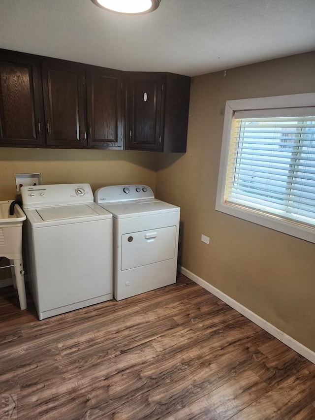 615 San Juan St, Trinidad, CO 81082 - laundry area with independent washer and dryer, cabinet space, and wood finished floors