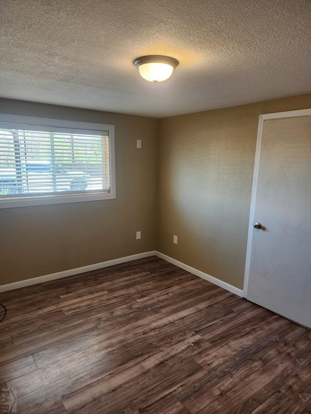 615 San Juan St, Trinidad, CO 81082 - empty room featuring a textured ceiling and dark wood-style floors
