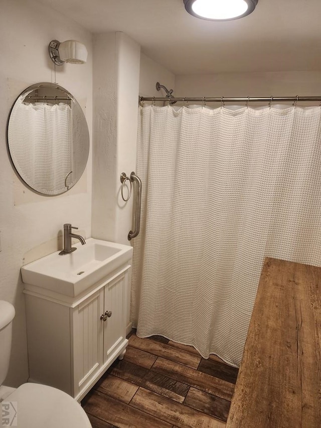 615 San Juan St, Trinidad, CO 81082 - bathroom with wood finished floors, vanity, and curtained shower