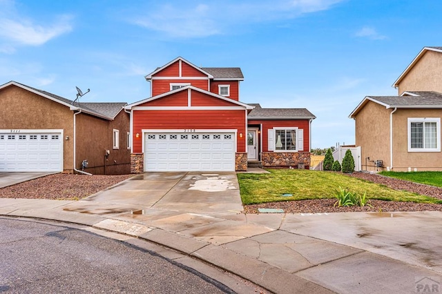 view of front of property with stone siding, concrete driveway, a front yard, and a garage