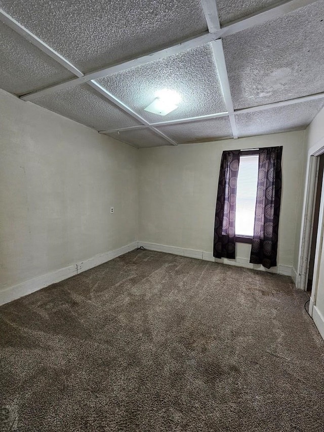 308 W Poplar St, Lamar, CO 81052 - empty room featuring carpet, a textured ceiling, and baseboards