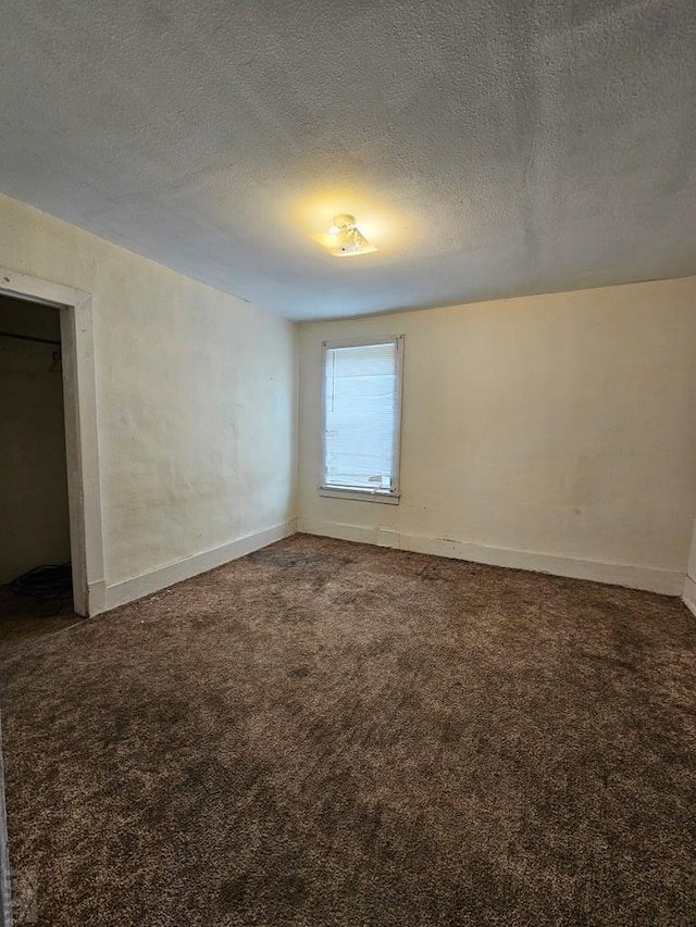308 W Poplar St, Lamar, CO 81052 - carpeted empty room with baseboards and a textured ceiling