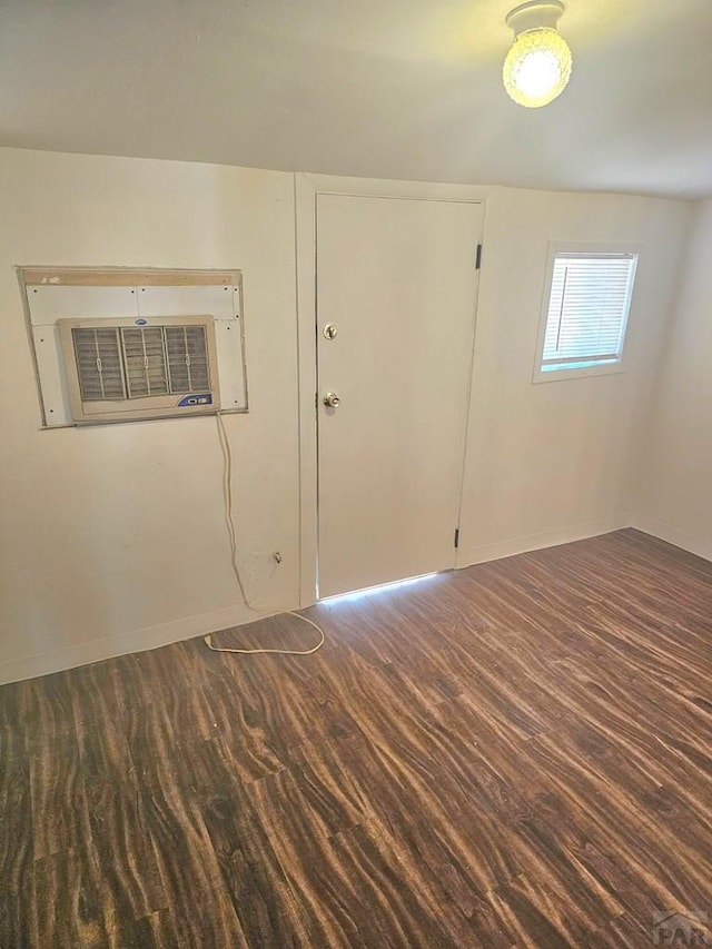 1337 Spruce St, Pueblo, CO 81004 - empty room featuring wood finished floors, baseboards, and a wall mounted AC