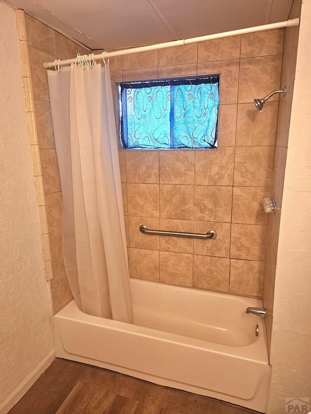 1337 Spruce St, Pueblo, CO 81004 - bathroom featuring shower / bath combination with curtain, wood finished floors, and a textured wall