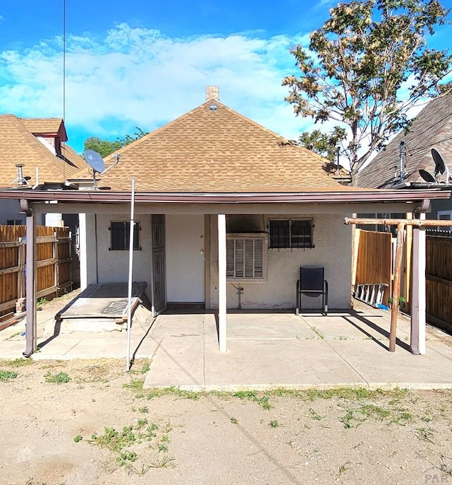 1337 Spruce St, Pueblo, CO 81004 - back of house with roof with shingles, a patio, and stucco siding