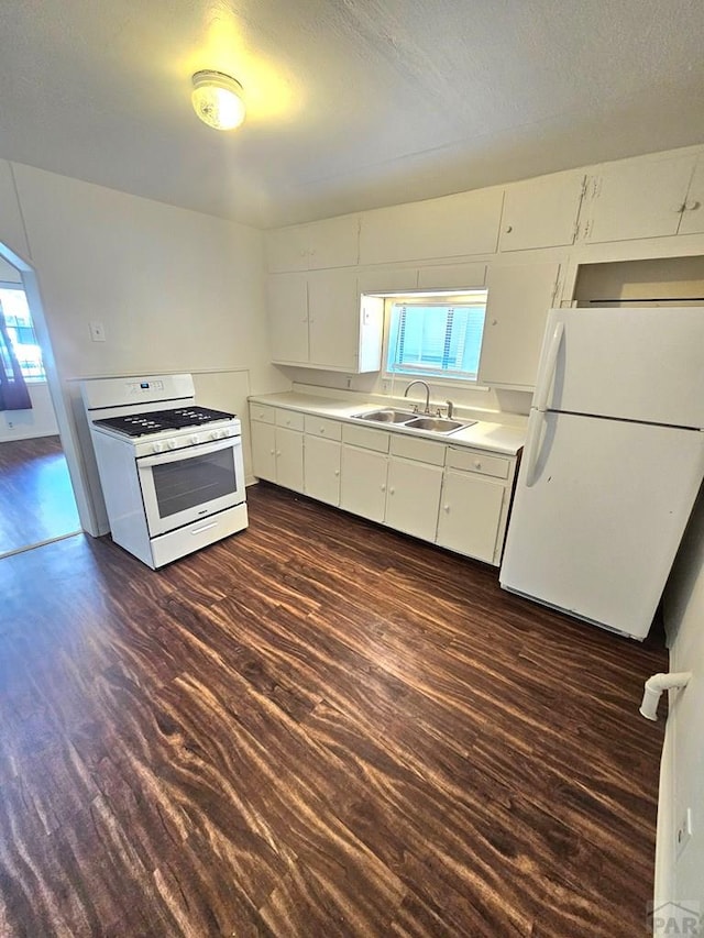 1337 Spruce St, Pueblo, CO 81004 - kitchen with white appliances, a sink, dark wood-style floors, and plenty of natural light