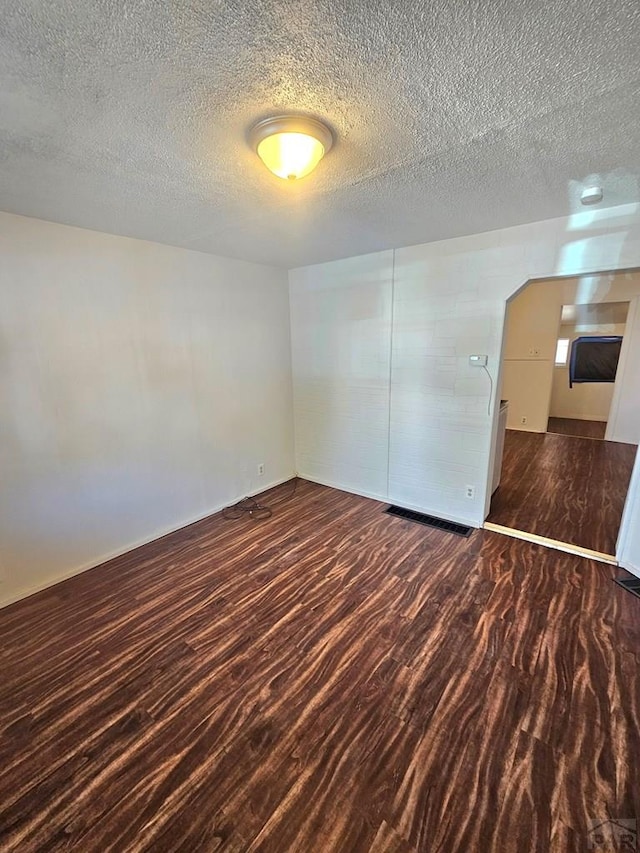 1337 Spruce St, Pueblo, CO 81004 - spare room with a textured ceiling, wood finished floors, and baseboards