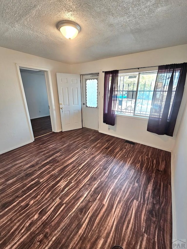 1337 Spruce St, Pueblo, CO 81004 - empty room featuring a textured ceiling, wood finished floors, and baseboards