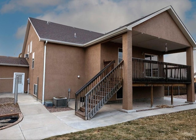 rear view of property featuring stairs, a patio, central AC unit, and stucco siding