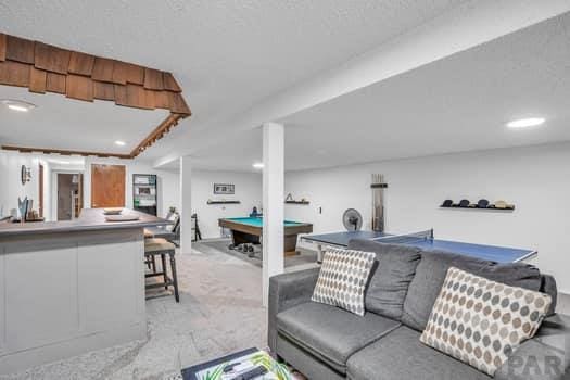 living room featuring light carpet and pool table