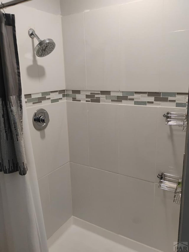 full bath with a tile shower