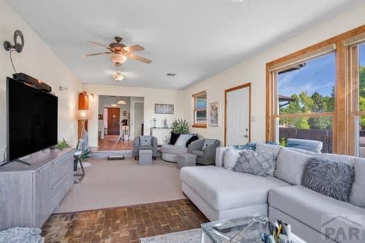 living area with ceiling fan