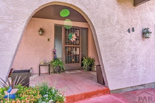 doorway to property featuring stucco siding