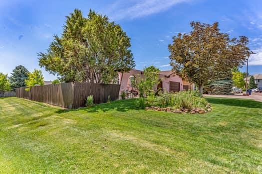 view of yard with a garage and fence