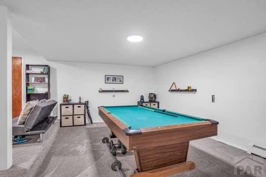 recreation room featuring a baseboard heating unit and pool table