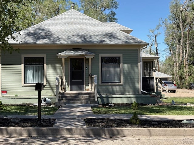 view of front of home featuring roof with shingles