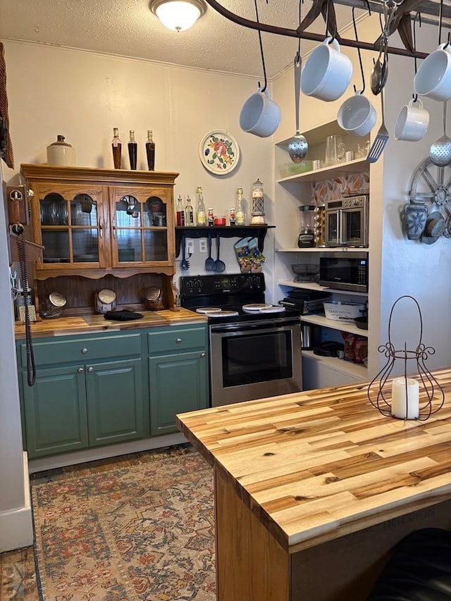 kitchen with appliances with stainless steel finishes, open shelves, a textured ceiling, and butcher block counters