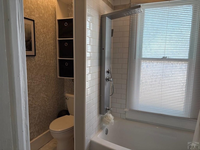 full bathroom with plenty of natural light, toilet, wallpapered walls, and  shower combination