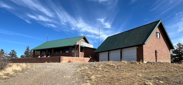 view of home's exterior with a garage and brick siding