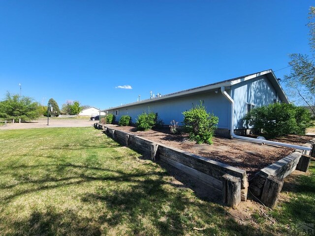view of side of home featuring a yard