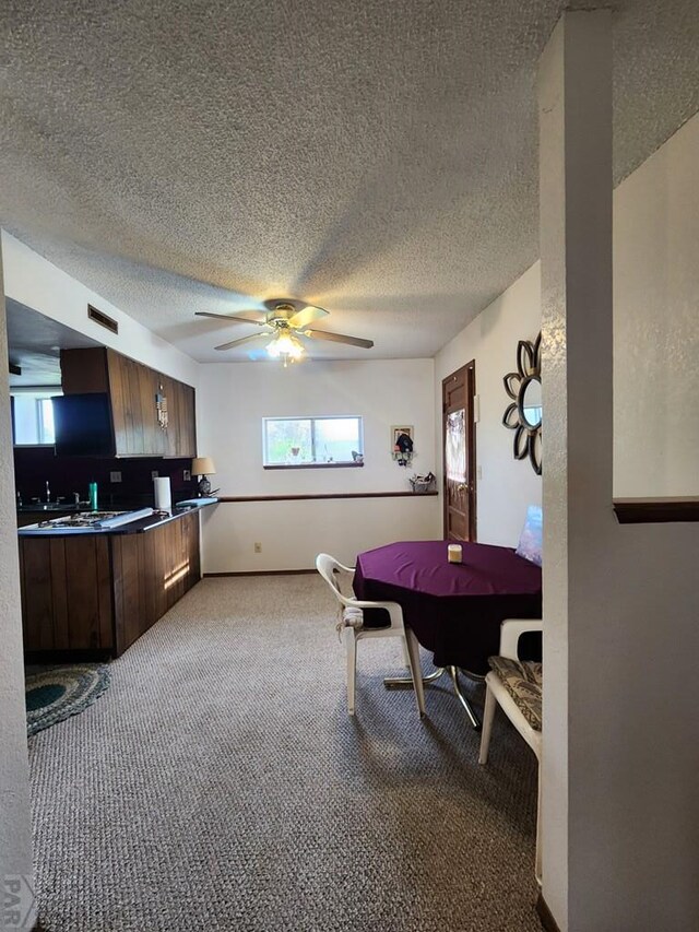 bedroom with a textured ceiling, visible vents, and light colored carpet