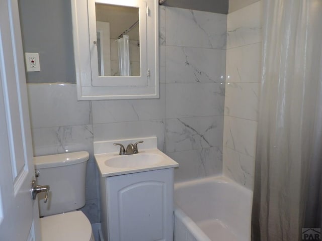 full bathroom with tile walls, tasteful backsplash, toilet, shower / bath combo with shower curtain, and vanity