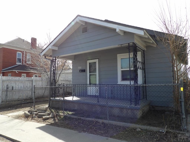 view of front facade with a porch and fence