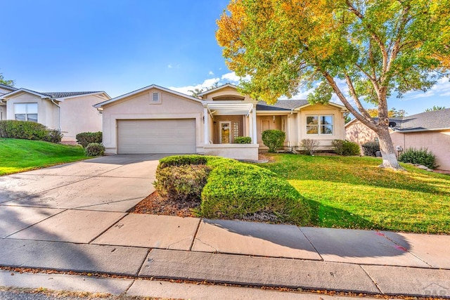 ranch-style house with a garage, a front yard, concrete driveway, and stucco siding