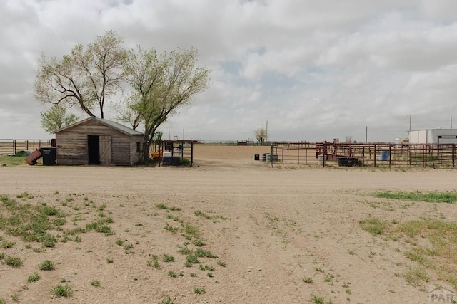 22661 Rd 24, La Junta, CO 81050 - view of yard with fence, an outbuilding, an exterior structure, and a rural view
