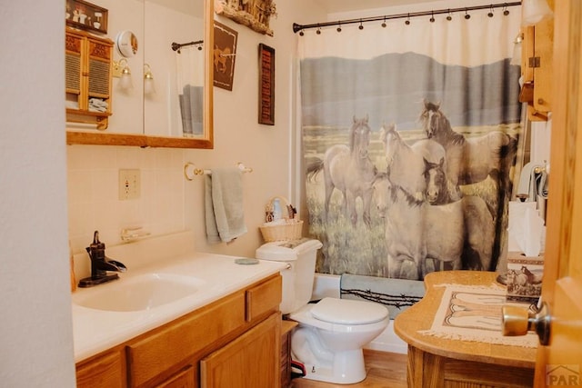 22661 Rd 24, La Junta, CO 81050 - bathroom featuring vanity, tasteful backsplash, and toilet