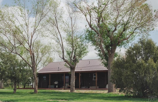 22661 Rd 24, La Junta, CO 81050 - rear view of house featuring a sunroom, a yard, and metal roof