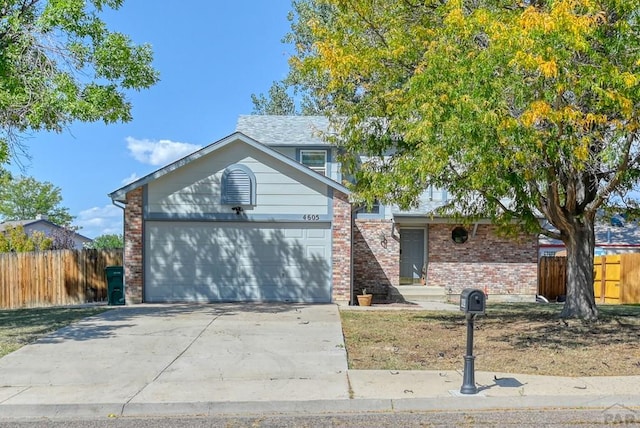 view of front of property featuring a garage, concrete driveway, brick siding, and fence