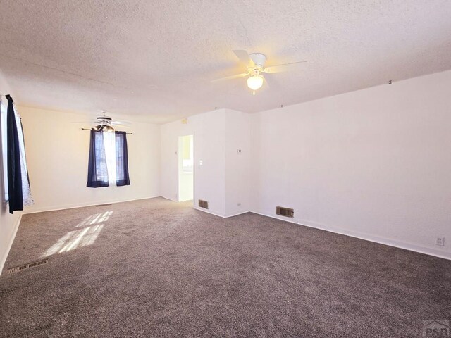 unfurnished room with ceiling fan, a textured ceiling, carpet, and visible vents